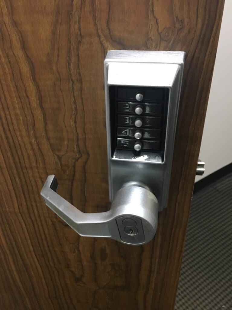 KABA SILVER COMMERCIAL LOCK WITH 5 BUTTONS AND A HANDLE WITH SCHALGE CYLINDER ON A BROWN BUSINESS DOOR-COMMERCIAL LOCKSMITH SERVICES