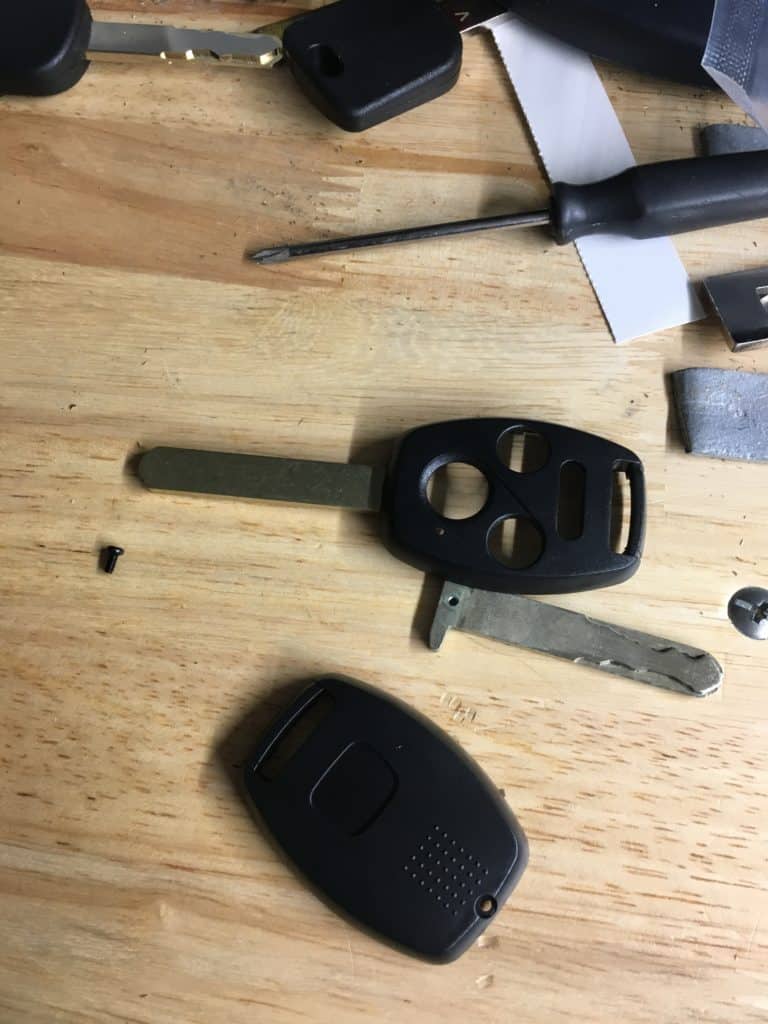 remote key head shell next to a blade broken blade after I broke my car key so fixing it to still use it