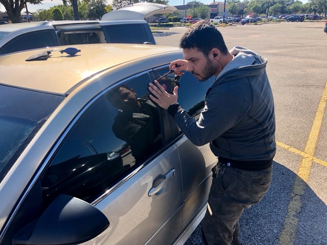 Professional mobile locksmith technician unlocking a car door in Houston, TX