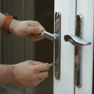 professional locksmith changing a door lock handle to improve home security